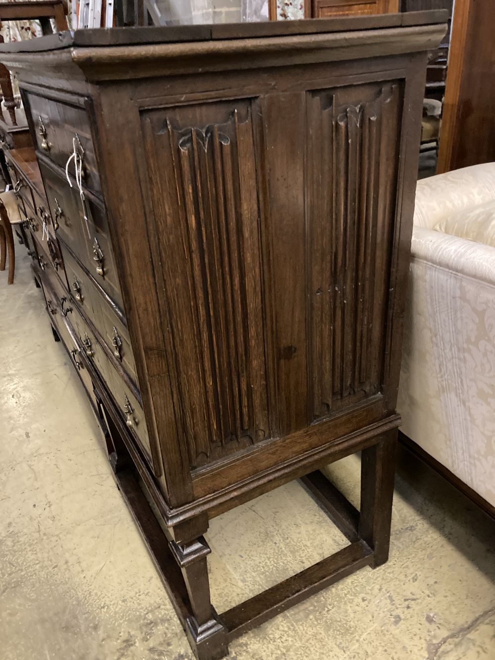 An 18th century style linenfold moulded oak and walnut chest on stand, width 73cm, depth 55cm, height 121cm